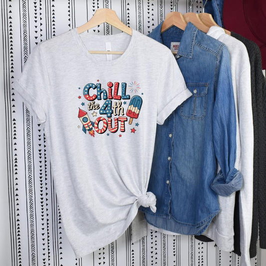 Chill the 4th Out grey t-shirt with colorful 4th of July fireworks and popsicle graphic on hanger
