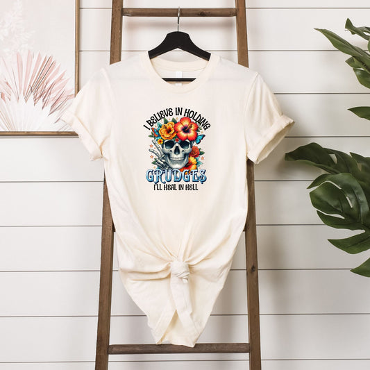 I Believe in Holding Grudges T-shirt Hanging in Soft Cream