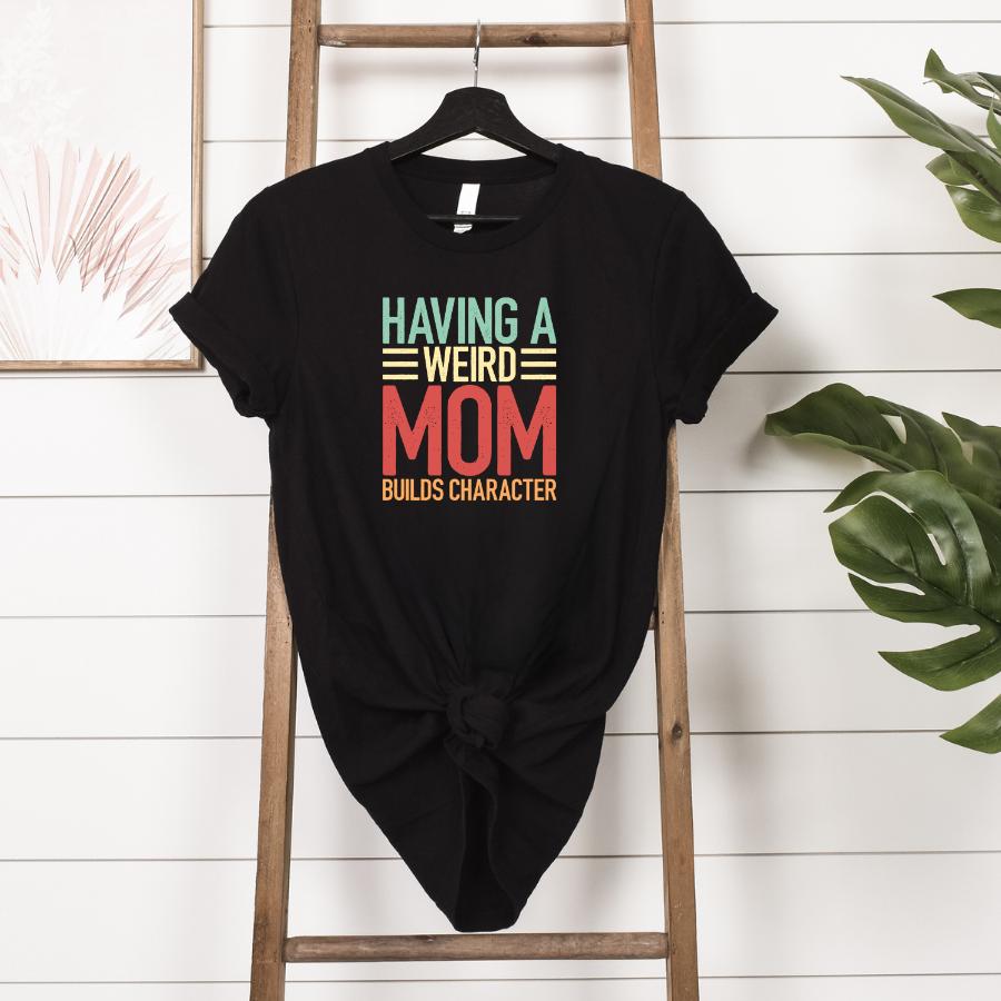 T-shirt - Having a weird mom builds character - hanging in black