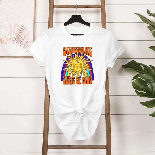 White Sunshine State of Mind T-shirt with colorful sun and rainbow graphic hanging on wooden ladder display