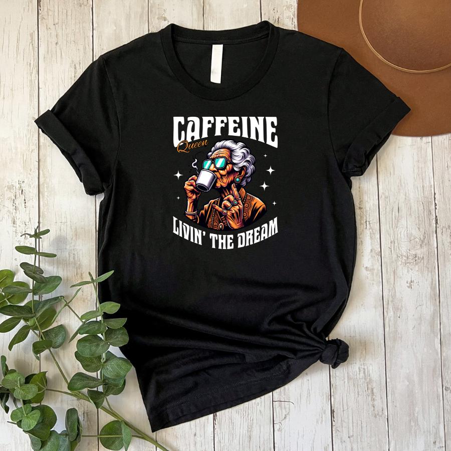 Caffeine Queen Livin' the Dream T-shirt flat lay in black 
