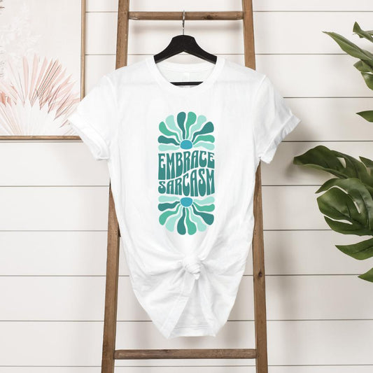 Embrace Sarcasm T-shirt hanging in white 