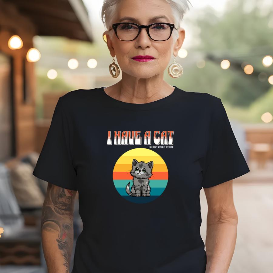 Woman wearing black "I Have a Cat So I Don't Actually Need You" T-shirt with cartoon cat and retro sunset design
